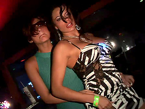 Two crazy brunettes demonstrate their tits and butts at a soiree