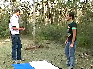 Outdoor gay blowjob by a guy in sunglasses with a dildo in his ass